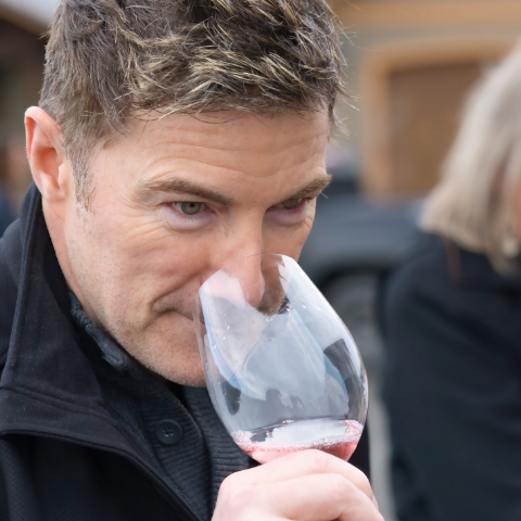 Man smelling wine while on a tour with Washington Wine Experience