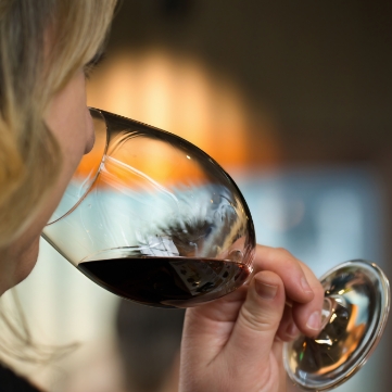 A woman sipping wine while touring with Washington Wine Experience
